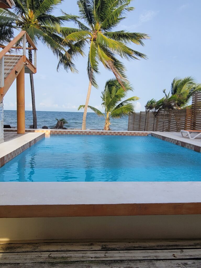 A pool and the beach in the distance