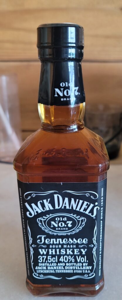 The half bottle of Jack Daniels on the refrigerator
